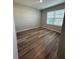 Bedroom with natural light through the window and wood-look flooring at 2439 White Lilly Dr, Kissimmee, FL 34747