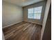 Bedroom with natural light featuring neutral colored walls and wood-look flooring at 2439 White Lilly Dr, Kissimmee, FL 34747