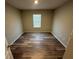 Bright bedroom with wood-look flooring and a window allowing natural light at 2439 White Lilly Dr, Kissimmee, FL 34747