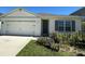 Inviting single-story home with a lovely garden and a two-car garage at 2439 White Lilly Dr, Kissimmee, FL 34747