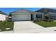 Charming single-story home with a well-manicured lawn and a two-car garage at 2439 White Lilly Dr, Kissimmee, FL 34747