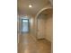 Hallway featuring tile floors, archways and neutral wall colors at 2439 White Lilly Dr, Kissimmee, FL 34747