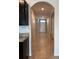 Hallway featuring tile floors, archways and neutral wall colors at 2439 White Lilly Dr, Kissimmee, FL 34747