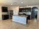Open concept kitchen with stainless steel appliances and granite countertops at 2439 White Lilly Dr, Kissimmee, FL 34747