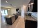 Modern kitchen featuring stainless steel appliances, granite countertops, and dark wood cabinetry at 2439 White Lilly Dr, Kissimmee, FL 34747