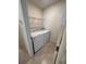 Close-up of a laundry room with a washer and dryer, next to the doorway at 2439 White Lilly Dr, Kissimmee, FL 34747