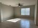 Spacious living room with tile flooring, ceiling fan and a large window at 2439 White Lilly Dr, Kissimmee, FL 34747