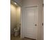 Clean powder room with a modern toilet and white door at 2439 White Lilly Dr, Kissimmee, FL 34747