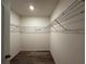 Spacious walk-in closet features ample storage with metal shelving and wood-look flooring at 2439 White Lilly Dr, Kissimmee, FL 34747