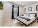 Cozy bedroom with dark curtains and tile flooring, featuring a comfortable bed and stylish decor at 253 Granada Blvd, Davenport, FL 33837