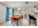 Open dining room with modern lighting and an adjacent screened patio view of the pool at 253 Granada Blvd, Davenport, FL 33837