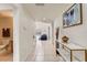 Inviting hallway with neutral tile flooring, console table and decor, leading to rooms filled with natural light at 253 Granada Blvd, Davenport, FL 33837