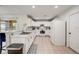 Bright kitchen featuring white cabinetry, a breakfast bar, and stainless steel appliances with natural light at 253 Granada Blvd, Davenport, FL 33837