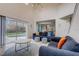 Open living area with high ceilings, comfortable seating, and sliding glass doors to the backyard pool at 253 Granada Blvd, Davenport, FL 33837