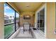 Inviting screened patio with seating, TV, and a view of the backyard at 253 Granada Blvd, Davenport, FL 33837