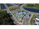 Beautiful aerial view of community pool, lazy river and clubhouse with lush landscaping at 2605 Reading Trl, Kissimmee, FL 34746