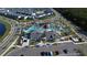Aerial view of community clubhouse with ample parking, pool, lazy river, and surrounding neighborhood at 2605 Reading Trl, Kissimmee, FL 34746