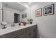 Double vanity bathroom with a large mirror, decorative art, and modern fixtures at 2605 Reading Trl, Kissimmee, FL 34746