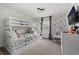 Bright bedroom features a bunk bed, Mickey Mouse decor, and window with natural light at 2605 Reading Trl, Kissimmee, FL 34746