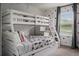 bedroom featuring a bunk bed with a playful Mickey Mouse themed wallpaper and window at 2605 Reading Trl, Kissimmee, FL 34746