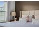 Stylishly designed bedroom with neutral tones, bedside lamp, and comfortable bedding for a relaxing atmosphere at 2605 Reading Trl, Kissimmee, FL 34746