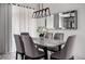 Dining room with stylish light fixture, mirror, seating for six, and ample natural light at 2605 Reading Trl, Kissimmee, FL 34746