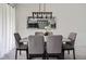 Dining room with modern light fixture, seating for six, and large mirror at 2605 Reading Trl, Kissimmee, FL 34746