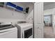 Convenient laundry room with modern washer and dryer, shelving, and closet at 2605 Reading Trl, Kissimmee, FL 34746