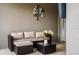 Comfortable outdoor patio with wicker furniture, decorative flower arrangement and wall art at 2605 Reading Trl, Kissimmee, FL 34746