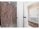 Bathroom featuring tile flooring, a seashell-themed shower curtain and access to the hallway at 2764 Patrician Cir, Kissimmee, FL 34746