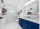 Bright bathroom featuring modern vanity, tiled shower, and elegant finishes at 2764 Patrician Cir, Kissimmee, FL 34746