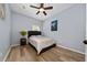 Cozy bedroom featuring hardwood floors, a ceiling fan, and a serene atmosphere at 2764 Patrician Cir, Kissimmee, FL 34746