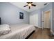 Charming bedroom featuring hardwood floors, a ceiling fan, and ample closet space at 2764 Patrician Cir, Kissimmee, FL 34746