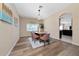 Stylish dining room with a modern chandelier, seating for six, and light wood floors at 2764 Patrician Cir, Kissimmee, FL 34746