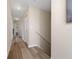 Hallway features hardwood floors, neutral paint and access to multiple rooms at 2764 Patrician Cir, Kissimmee, FL 34746