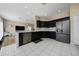 Spacious kitchen featuring stainless steel appliances, tile floors, and black cabinetry at 2764 Patrician Cir, Kissimmee, FL 34746