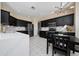 Modern kitchen with black cabinetry, stainless steel appliances, white countertops, and stylish backsplash at 2764 Patrician Cir, Kissimmee, FL 34746