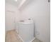 Functional laundry room equipped with washer, dryer, and tile flooring at 2764 Patrician Cir, Kissimmee, FL 34746