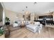 Open living area showcasing hardwood floors, a large sofa, and access to the kitchen at 2764 Patrician Cir, Kissimmee, FL 34746