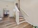 Inviting foyer with a staircase featuring wood and white risers and a light wood floor at 2764 Patrician Cir, Kissimmee, FL 34746