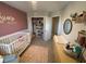 Another view of the charming Bedroom with a crib, changing table, and cozy decor at 2883 Narcoossee Commons Way, St Cloud, FL 34771
