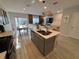 Modern kitchen featuring an island with seating, stainless steel appliances, and ample counter space at 2883 Narcoossee Commons Way, St Cloud, FL 34771