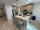 Bright kitchen featuring an island with seating, stainless steel appliances, and stylish pendant lighting at 2883 Narcoossee Commons Way, St Cloud, FL 34771