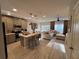 Stylish kitchen with gray cabinets, stainless steel appliances, and an island with bar seating at 2883 Narcoossee Commons Way, St Cloud, FL 34771