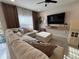Cozy living room featuring a large sectional sofa, TV, and plenty of natural light at 2883 Narcoossee Commons Way, St Cloud, FL 34771