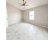 Bright bedroom featuring modern tile flooring, neutral paint, ceiling fan, and natural light at 3208 Timberline Road, Winter Haven, FL 33880