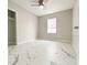 Bright bedroom featuring modern tile flooring, neutral paint, ceiling fan, and closet at 3208 Timberline Road, Winter Haven, FL 33880