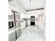 Bright kitchen features white cabinets, stainless steel appliances, and stylish marble floors at 3208 Timberline Road, Winter Haven, FL 33880