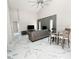 Inviting living area with a fireplace, modern furnishings, and large windows for natural light at 3208 Timberline Road, Winter Haven, FL 33880