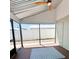 Enclosed patio with brick flooring, ceiling fan, and screen windows providing views of the fenced backyard at 3208 Timberline Road, Winter Haven, FL 33880